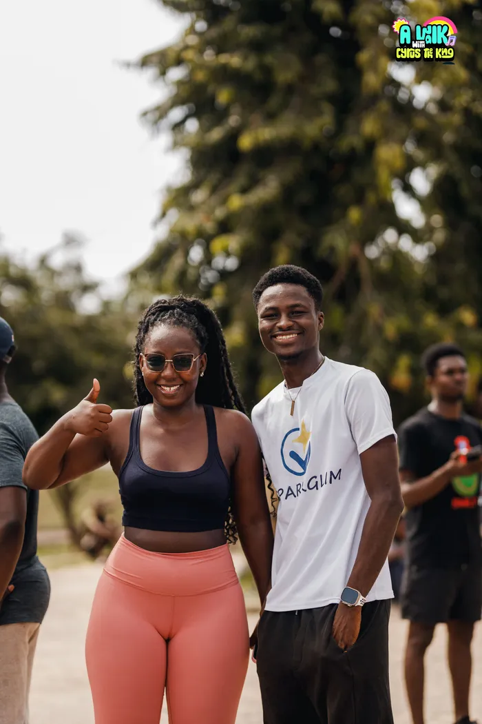 A participant and a SparkGlim team member at an outdoor event